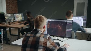 office of computer game development company, young male IT specialists and 3D designers