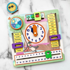 What's the time? It's time to play My Fun Day! This wooden activity board is perfect for young learners to explore and learn about telling time, days of the week, and other fun details in their day. It's also a cute addition to any playroom! Nurture your toddler's love for learning through sensory play. Shop for My Fun Day: https://bit.ly/myfunday-fb | SimplyFun