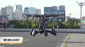A flying car took to the skies outside the Tokyo Big Sight convention center on Friday. During the demo flight, the vehicle hovered around 32 feet in the air and did some twists and turns. | CBS Mornings