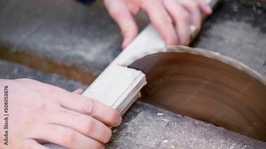 Cutting an old wooden window frame on a circular saw. Recycling of dismantled wooden windows. Stopping the clog of an old rusty blunted circular saw