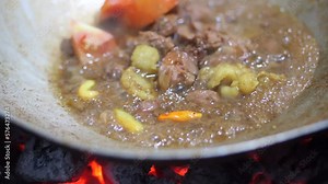 Preparing tongseng kambing. Tongseng is an Indonesian Central Java goat meat muttonor beef stew dish in curry-like soup with vegetables and sweet soy sauce. Preparing Goat Curry or Lamb Curry