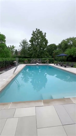 Hidden Luxury: Discover the Stunning Pool Oasis Behind this Elegant Home