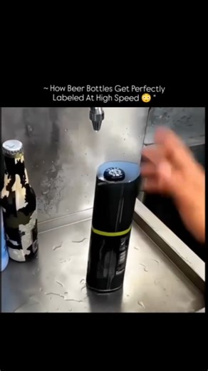 @the.explainerr on Instagram: "Beer bottle labels are applied using automated labeling machines designed for speed and precision. After bottles are cleaned and filled, they move along a conveyor system toward the labeling section. Sensors detect the exact position of each bottle so the label can be placed at the correct height and angle every time. An adhesive applicator or pressure-sensitive roller applies glue or stickers smoothly onto the bottle surface. The label is then pressed firmly to re