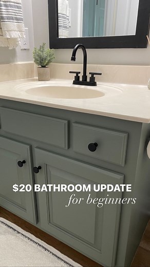 Liz Pacini on Instagram: "$20 vanity makeover! Here’s exactly how I painted these old wooden cabinets. Would you try this?! Step by step process written out on www.lizpacini.com! All decor linked on my Amazon storefront or LTK 🪴 #bathroomremodel #diybathroom #diyprojects #farmhousebathroom #amazonbathroom #farmhousedecor #budgetfriendlydiy"