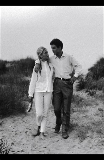 Brigitte Bardot and Jacques Charrier appear together at the height of French cinema’s golden glow, their smiles hinting at romance while the cameras never blink. Bardot, already a global icon, moves with effortless magnetism, while Charrier stands close, protective yet quietly overwhelmed by her fame. Their love feels real, tender, but strained under relentless attention and expectations. In every shared glance, you sense both passion and pressure—two hearts trying to find privacy in a world tha