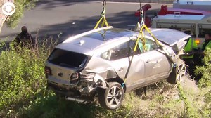 The car Tiger Woods was driving during a crash in California was lifted and moved back to the road Tuesday afternoon (2/23). Woods was hospitalized with multiple leg injuries, according to the golfer's agent. | CBS Newspath