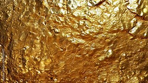Shiny gold foil texture shifting in bright light close-up