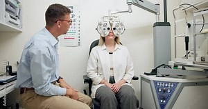 Ophthalmologist, woman and eye exam for vision, healthcare or wellness in consultation. Medical test, optometry and patient on phoropter machine for eyesight or check on lens with doctor in clinic