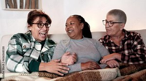 Multiracial senior friends having fun together at home in winter holidays - Older people friendship and love relationship