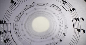 White paper with musical notes rolled up closeup and bright light. Music writing and inspiration concept