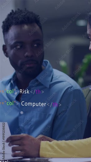 Vertical video: Man reading paper after coworker pointing, reviewing IT with scrolling code overlay