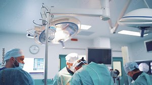 Contemporary equipment in operating room. Group of surgeons performing an operation in medical clinic. Neurosurgery.