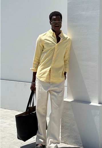 Sun’s out. @Babac Saintcloud styles the Steel Solid Slim Fit Button-Down Shirt for any destination. Paired with a sleek leather tote and new denim.