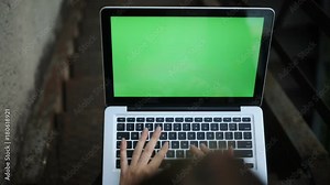 Close-up top view girl hands using modern laptop keyboard typing text notebook green screen chroma-key mock up freelance writer working outdoors chatting media network internet browser 3g technology