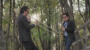 Musicians playing wind instruments in the forest - Free Stock Video