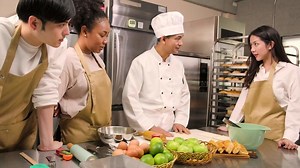 Download Cuisine course, senior male chef in cook uniform teaches young cooking class students to knead pastry dough and prepare ingredients for bakery foods, fruit pies in restaurant stainless steel kitchen. for free