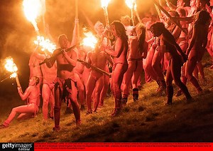 Naked revellers wave flaming torches in Edinburgh as they celebrate Beltane Fire Festival