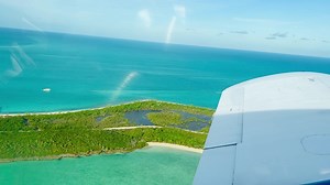 Our friends know a pilot with an Island hopper that came to pick us up at first light this morning. This island, Norman’s Cay, was famous for being developed and used by Pablo Escobar in running drugs for the Medellin Cartel. Guess we know how it came to have a runway! It is now being developed with charming cottages for the adventurer who wants a quiet escape from the world. | Lisa Robertson