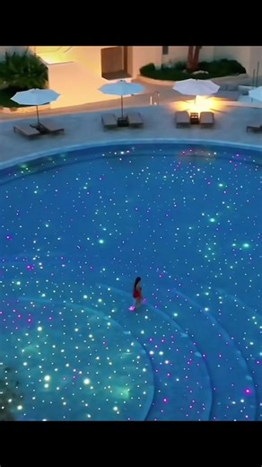Mesmerizing Nighttime Pool Scene with Colorful Lights