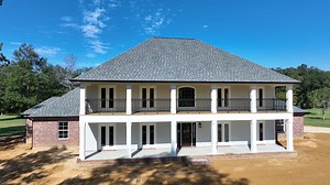 There are so many things to love about this custom Kingsbridge built by our Baton Rouge - New Orleans team! This home infuses French Country charm with plenty of space, making it the perfect family home. Unique to this home is a squared-off front exterior with a two-story front porch that extends the entire width of the home. View Plan: https://schuhomes.co/3U6U4ae | Schumacher Homes