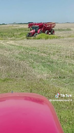 Red Tractor in Action: Farming Across Vast Fields
