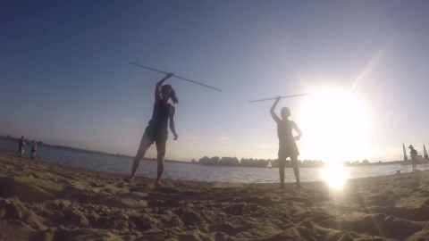 Friends Practice Martial Arts Moves at Beach