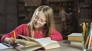 Happy child doing her homework - Free Stock Video