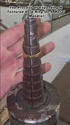 The Process Of Expanding A Textured Gold Ring On A Metal Mandrel