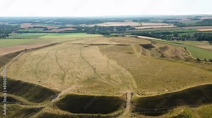 Maiden Castle, Dorset UK. Fly out video E. over W. entrance prehistoric Iron Age hillfort ramparts and ditches dates from 4000 BC causewayed enclosure