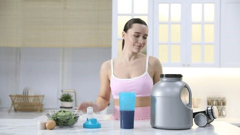 clip-4002670511-woman-making-protein-shake-white-marble-table