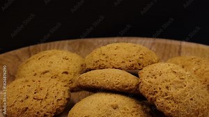 A close-up of oatmeal cookies rotating on a turntable. Baking overview.