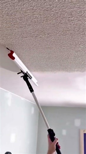 applying a thick textured plaster finish to a ceiling using a roller to create a unique pattern
