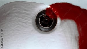 Blood with water flows down the drain hole in the shower. Concept blood, blood pressure, pool of blood on the shower.