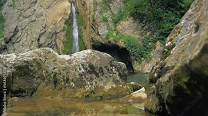 Waterfall in Slow motion. Mountain waterfall formed by spring streams. The spring melting of snow in the mountains gives rise to turbulent streams of water flowing from the mountains into the valleys.