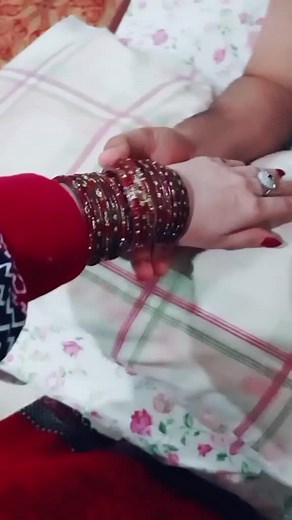 Elegant Hand Adorned with Red and Gold Bangles