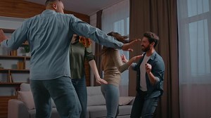 Four multiracial friends ethnic diversity buddies people dancing at home party multiethnic men women together dance to music active moving having fun funny celebrate event relocation holiday weekend