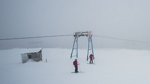 Skiers on a misty snowy mountain - Free Stock Video