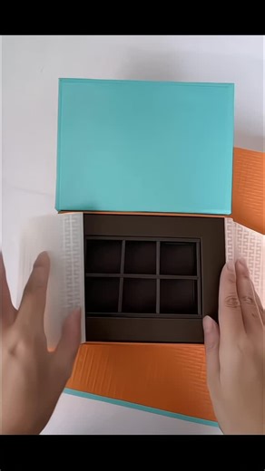 YY-Package on Instagram: "Premium Chocolate Packaging || An orange and blue chocolate gift box design Featuring food-grade paper inserts Textured embossing Foil stamping with embossing #ChocolateGiftBox #GiftBoxPackaging #CustomPackagingFactory #YouthOrientedPackaging #FoodPackagingDesign"