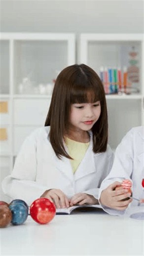 clip-4184131223-young-students-white-lab-coats-learn-astronomy