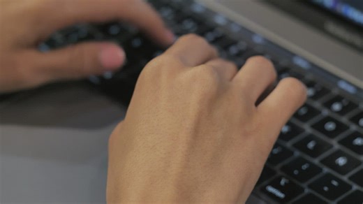 Close up shot of a person typing on a laptop - Free Stock Video