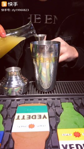Pouring classic margarita cocktail with tequila and lemon garnish creating smooth citrus drink