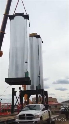 Setting the asphalt silo in place — precision crane work.