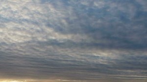 Scenic sunset over the ocean, time lapse. Backlit clouds at sunset