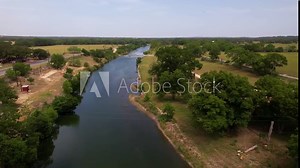 Aerial footage of the Blanco River in Blanco Texas in the Texas Hill Country. High fast flight heading straight.