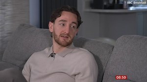 Luton Town defender shows where defibrillator is fitted in his chest