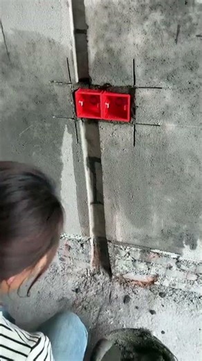 Electrician demonstrates the process of installing electrical boxes indoors