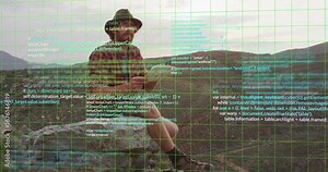 Man climbing rock and writing notes starting green grid overlay while analyzing code for technology