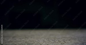 Close up of a hand grabbing a pint of beer and pulling it off of a bar with right hand