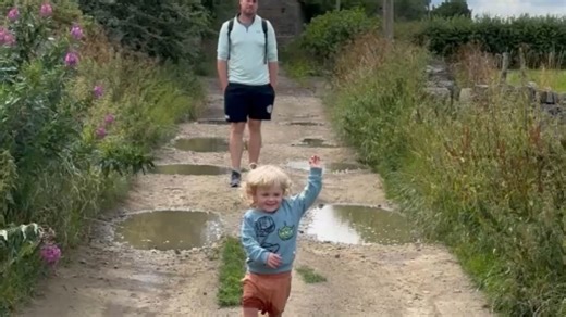 Family walk turns adorable and messy when toddler falls into a muddy puddle