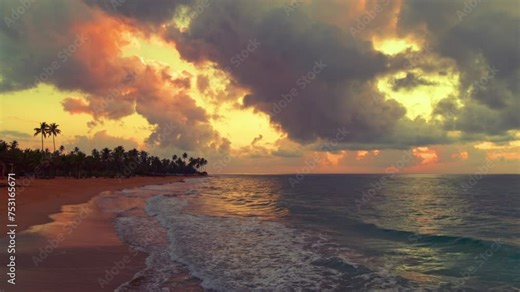 Beautiful panoramic sunset on a tropical Dominican beach. Calm summer holiday or festive landscape. Sea sunset on the coast with palm trees. Calm waves. Exotic view of nature. Inspiring seascape